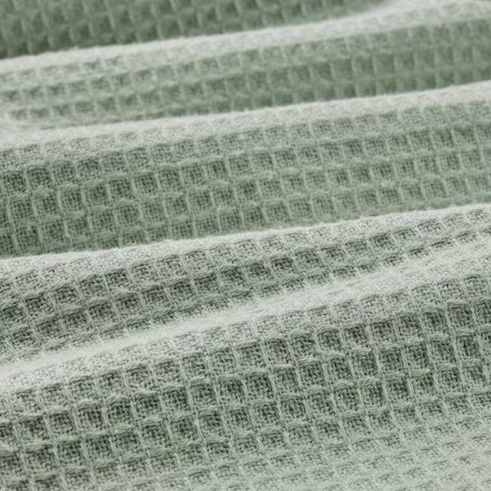 A close-up image of an IKEA hand towel in light green with a soft and absorbent surface 90512548 