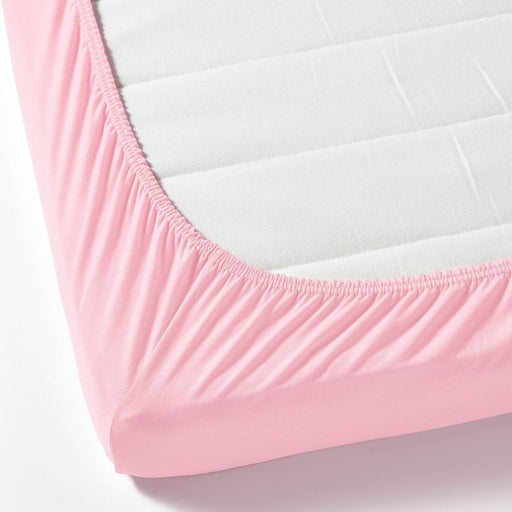 A close-up photo of an IKEA fitted sheet in pink with elastic edges to fit snugly over a mattress  40465295
