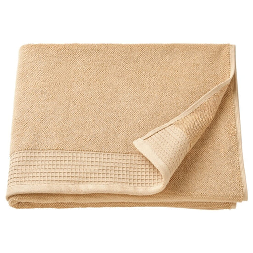 A light yellow bath towel, 70x140 cm, folded neatly on a towel rack.40508332