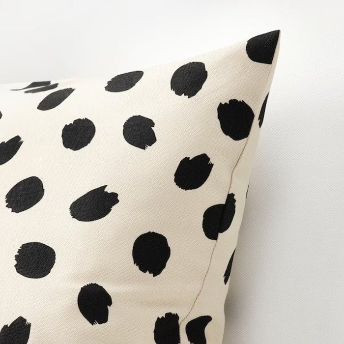 A close-up of an IKEA Cushion cover, off-white/dot pattern black on a white background-20523828