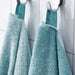 A close-up image of a folded white/turquoise hand towel with a textured pattern and simple, classic hand towel, perfect for every bathroom 20494388
