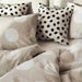 Multiple IKEA cushion covers in different colors and designs on a bed-20523828