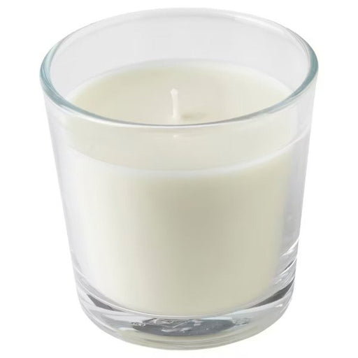 A scented candle in an elegant glass holder, perfect for creating a warm and inviting atmosphere in any room.