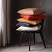 Multiple IKEA cushion covers in different colors and designs on a chair -40456540