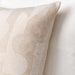 A close-up image of an IKEA cushion cover made from soft, beige fabric with a Decorative and discreet jacquard-woven pattern-30486689