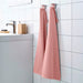 A close-up image of a simple and classic pink hand towel hanging on a bathroom hook70456317 
