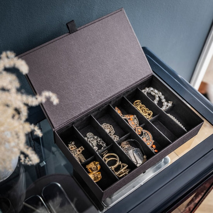 A  box with compartments designed for jewelry storage, featuring several  compartments for organizing different types of jewelry such as chain, bracelets, and watches 90476767