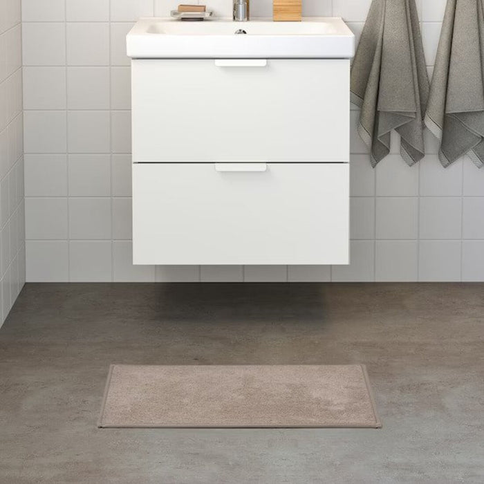  IKEA bath mat placed on a bathroom floor, featuring a soft and absorbent texture and a non-slip bottom for secure footing 50514200