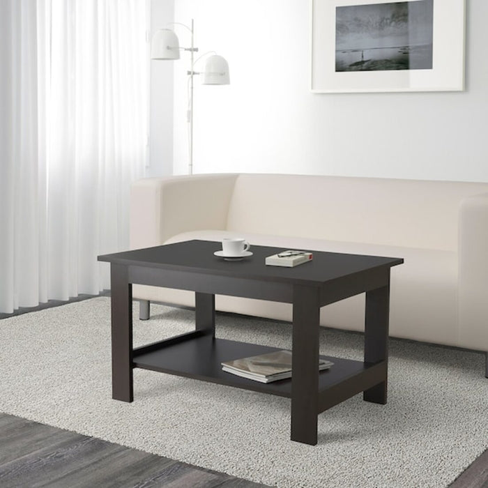 IKEA coffee table with a wooden top and black metal legs, placed in a cozy living room with a fireplace, a sofa 