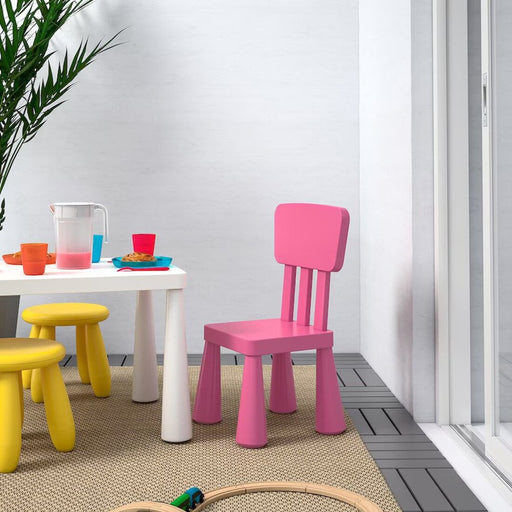 A pink IKEA Children's Chair with a lightweight, stackable design, made from durable plastic and featuring a smooth, curved seat and backrest for optimal comfort and suppor