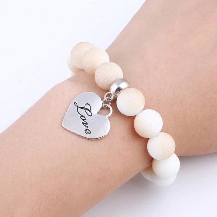 A charm bracelet with various shaped and sized charms-White & Beige (SL704)