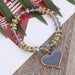 "A braided friendship bracelet with a heart-shaped charm"