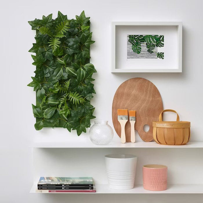 A wall-mounted IKEA artificial plant with lush green leaves