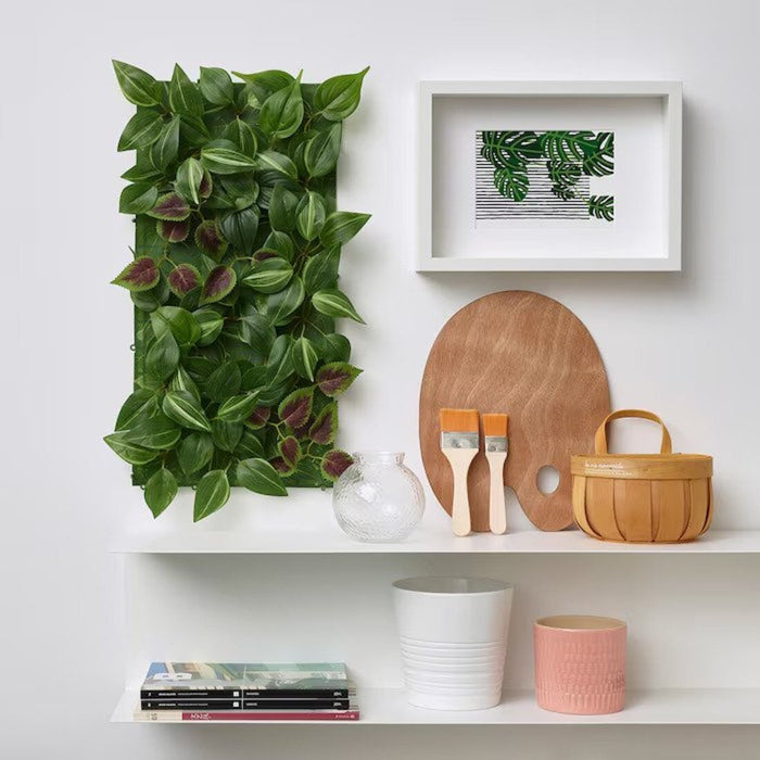 An IKEA artificial plant on a shelf in a home office