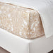 A closeup image of IKEA fitted sheet on a bed with neatly tucked corners and a smooth surface-70549699