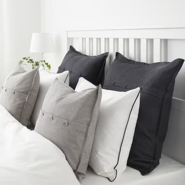 A close-up of a White/dark grey  cushion cover, adding a modern touch to a bedroom's decor   10432659