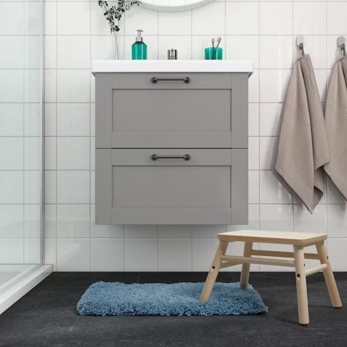 Soft and absorbent blue IKEA bath mat on a bathroom floor, providing comfort for the feet  40551759 