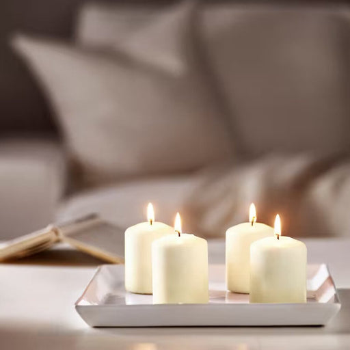 An unscented block candle from IKEA, housed in a sleek glass holder that adds a touch of elegance to your home decor.