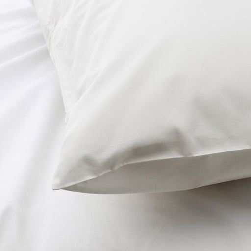 The edge of a white pillowcase from IKEA, highlighting its bright and cheerful color 10342748
