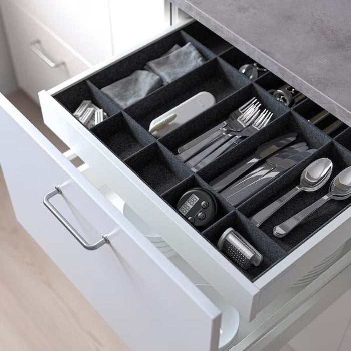  IKEA Adjustable Organizer in Grey, demonstrating its slim profile and efficient use of space inside a kitchen drawer."