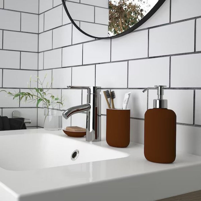 Bathroom accessories set: A set of four brown bathroom accessories including a toothbrush holder, soap dish, soap dispenser, and toilet brush.