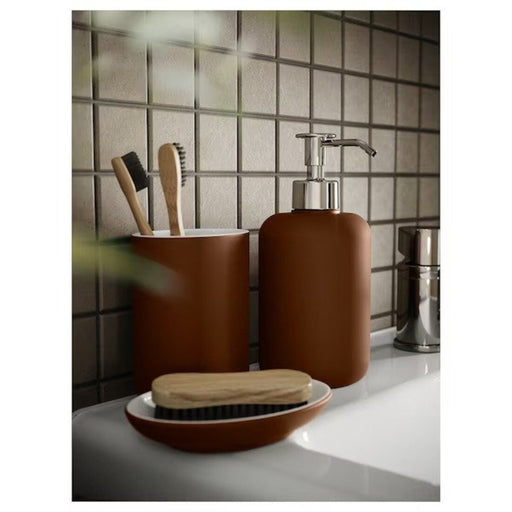 The IKEA Soap Dispenser in Brown installed on a bathroom or kitchen sink, dispensing soap with ease