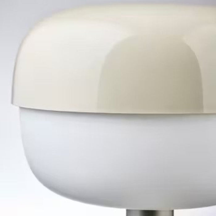 Close-up of the adjustable arm and head of IKEA's 36 cm beige table lamp   70520931          