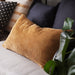 A dark beige cushion cover with a modern, minimalist design