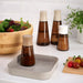 The IKEA spice jars/bottles tray being used to store and organize other kitchen items like oils, vinegars, and condiments  60539460