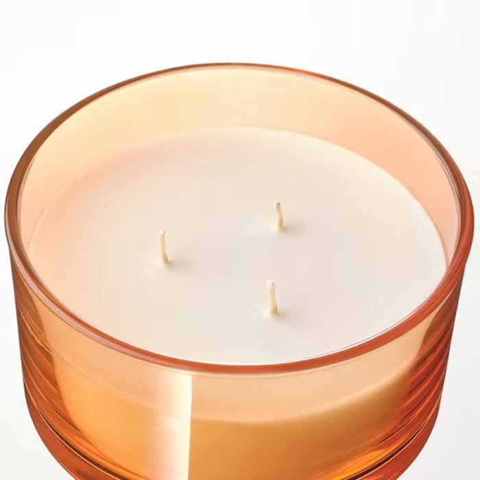 A beeswax candle in a honeycomb texture, burning slowly with a golden flame-30527213                  