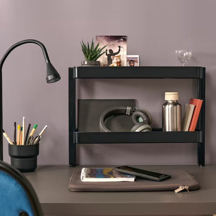 A picture of a stylish and functional IKEA black desktop shelf with a plant, picture frame, and books displayed on it 60541571