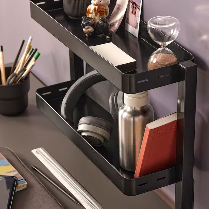 A close-up of an IKEA Black desktop shelf with compartments for storing small items 60541571
