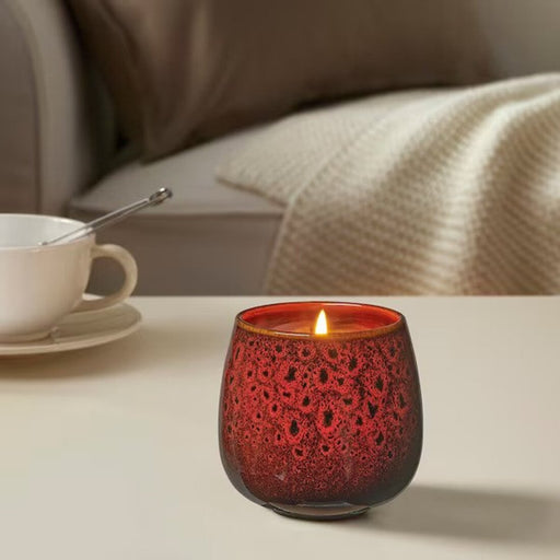 A beeswax candle in a honeycomb texture, burning slowly with a golden flame-90519314