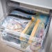 Multiple IKEA's resealable bags organized in a kitchen drawer  70525679