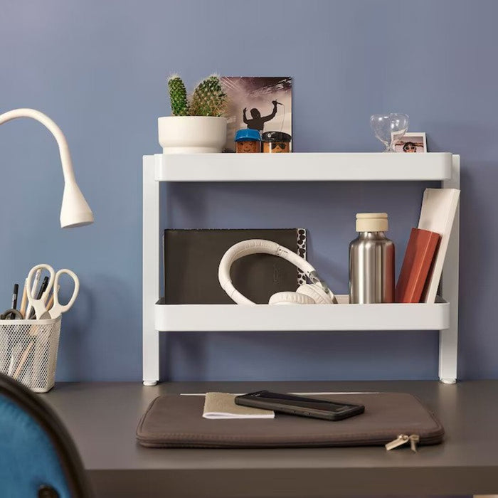 A picture of a stylish and functional IKEA desktop shelf with a plant, picture frame, and books displayed on it v