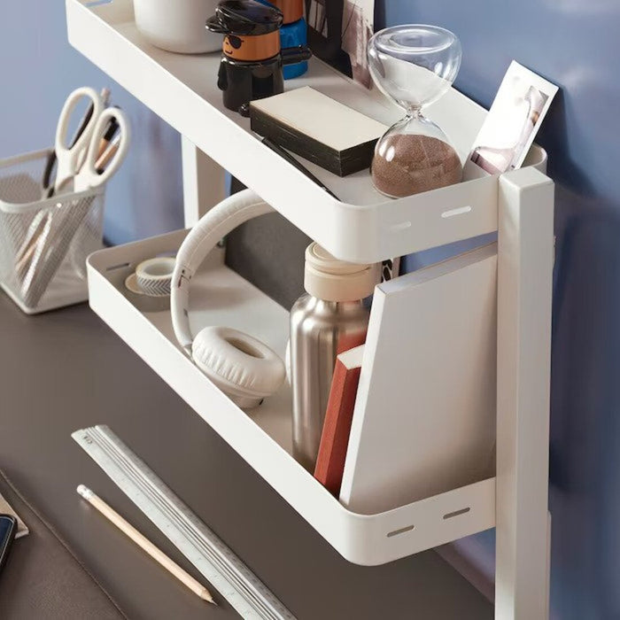 A close-up of an IKEA White desktop shelf with compartments for storing small items 00541569