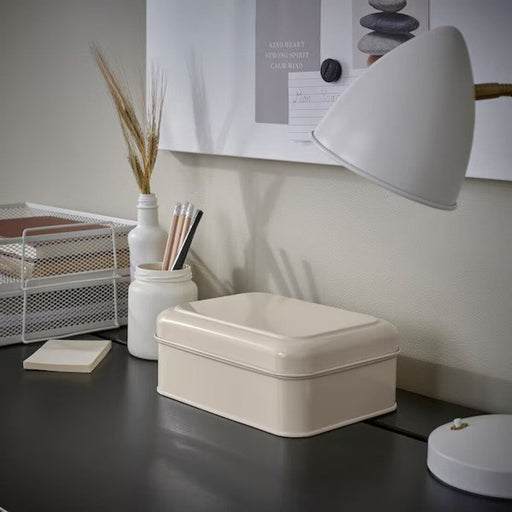 Store your belongings in style with the chic IKEA light beige storage box with lid. Its 22x16x8 cm size and sturdy design make it a versatile storage solution for any space-Digital Shoppy IKEA 