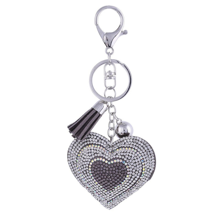 Women's crystal heart-shaped key charm with a tassel.