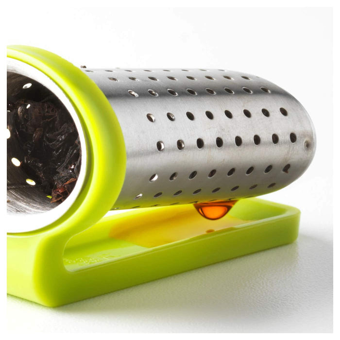 A close-up of a stainless steel tea infuser with fine mesh, containing steeped tea leaves. 00458305