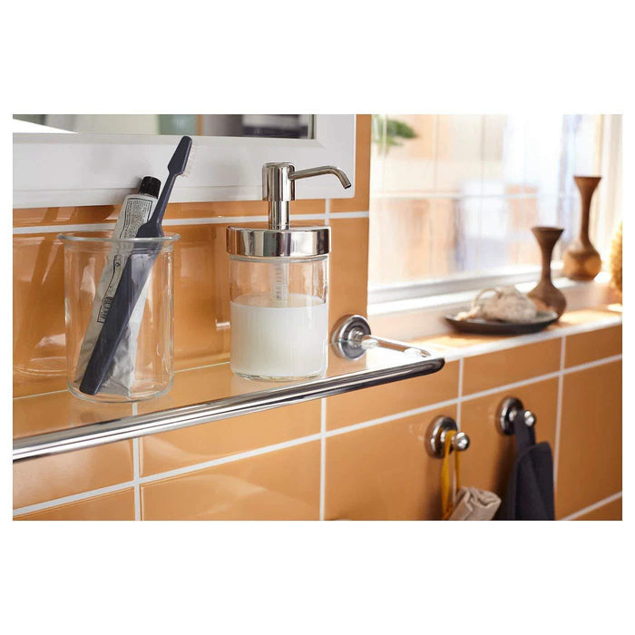 Beautifully crafted soap dispenser with a clear glass body and shiny chrome pump 00328979