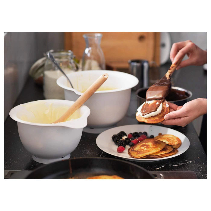 Image of the mixing bowls in use: "The white IKEA mixing bowls being used to mix ingredients for a recipe."