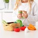 A child using their imagination with a 14-piece vegetables set from IKEA, creating fun and interactive scenarios 00515221