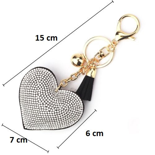 A silver-colored key chain with a crystal heart charm and engraved details