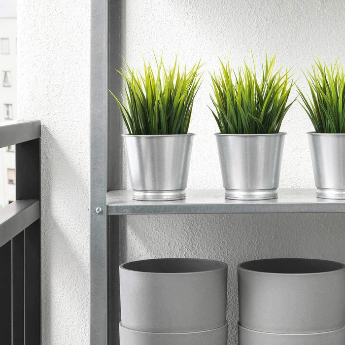 A silver steel IKEA plant pot with green succulent.