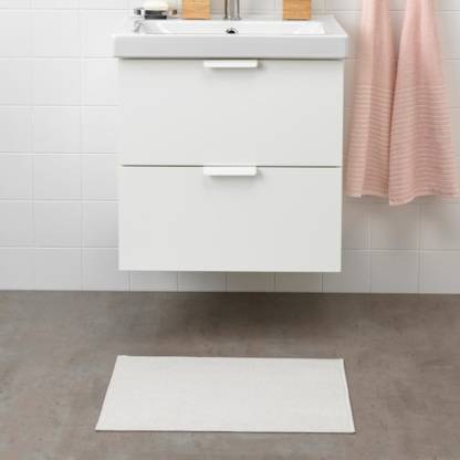 IKEA bath mat placed on a bathroom floor, featuring a soft and absorbent texture and a non-slip bottom for secure footing 70443706