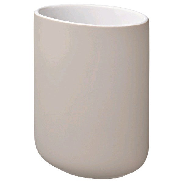 Beige toothbrush holder: A beige toothbrush holder with four slots to hold toothbrushes.